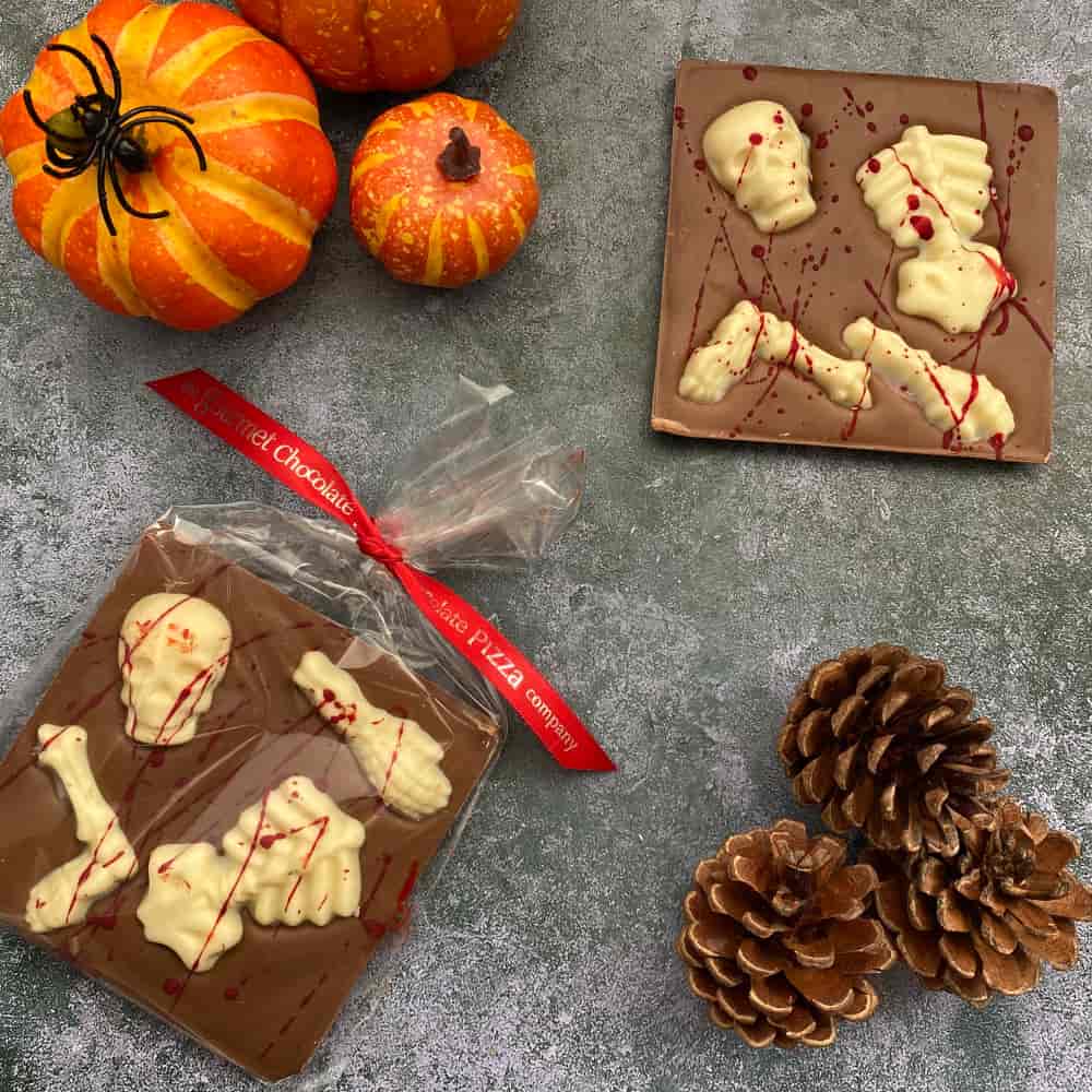 Our Skeleton-themed Halloween Bars are splashed with red cocoa butter to give a 'blood' splatter effect.